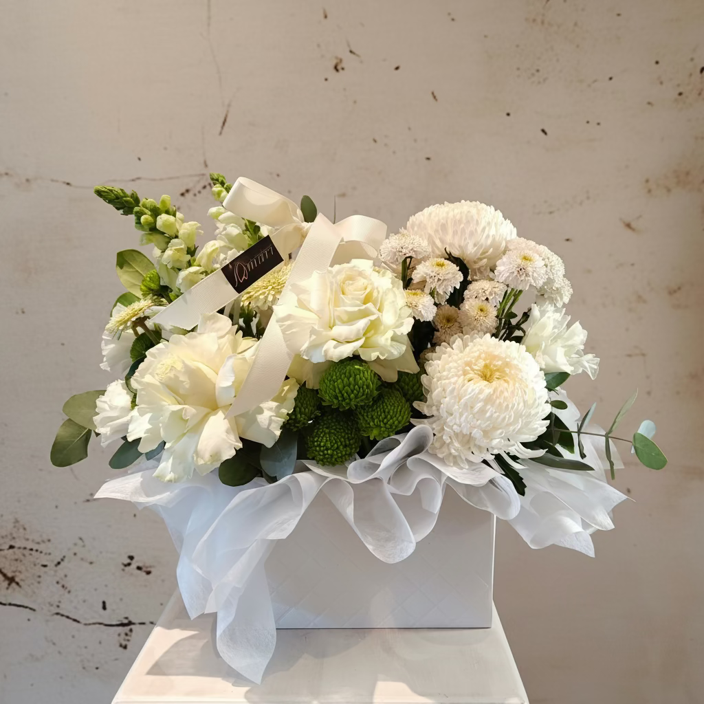 "Pristine White" flower arrangement in flower bag